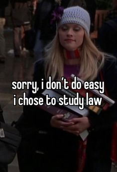 a girl holding a book with the words sorry i don't do easy i chose to study law