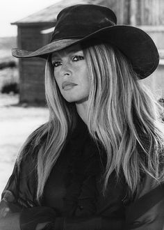 a woman with long hair wearing a cowboy hat