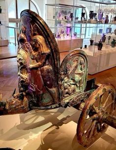 an antique carriage is on display in a museum