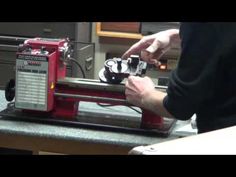 a man working on a machine in a shop