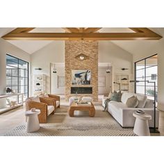 a living room filled with furniture and large windows