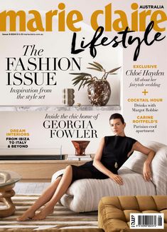 a magazine cover with a woman sitting on a couch