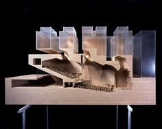 an architectural model of a building made out of wood