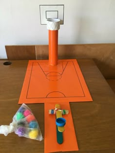 the basketball court is made out of construction paper and plastic cups with markers on it