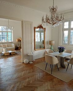 a dining room table with chairs and a chandelier