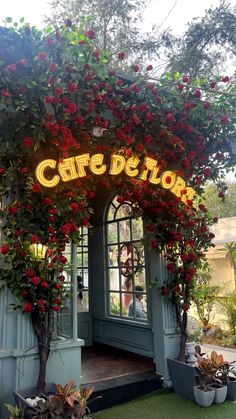 the entrance to cafe before with roses growing on it