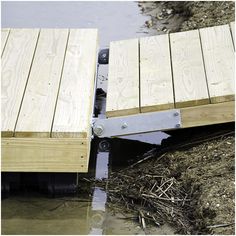 a wooden dock sitting on top of a muddy river