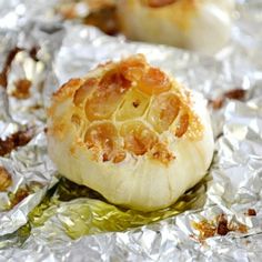 garlic on foil with text overlay that reads 10 ways to use roasted garlic