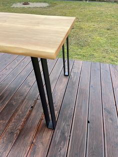 a wooden table sitting on top of a wooden deck