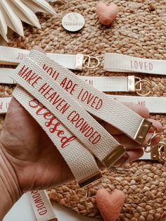 a person holding onto some type of keychain that says, you are loved