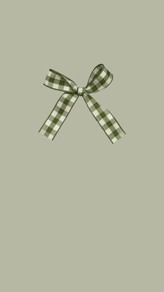 a green and white checkered bow on a gray background