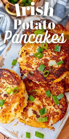 three potato pancakes on a white plate with green onions and parsley in the background