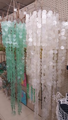 there are many plastic bottles hanging from the ceiling in this store, and they look like bubbles