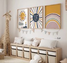 a child's room decorated in neutrals and whites with giraffe art on the wall