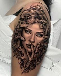 a woman's face with snakes around her head and eyes on the upper half of her arm