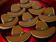 there are many cookies shaped like hats on the plate