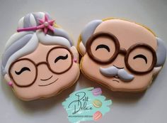 two decorated cookies with glasses and mustaches on top of each cookie, one has an older man's face