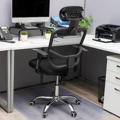 an office desk with a computer and printer on it