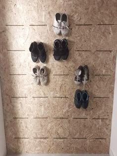 there are several pairs of shoes hanging on the wall