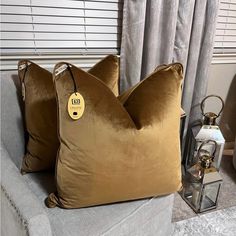 two brown pillows sitting on top of a couch