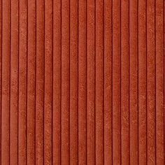 an orange textured wall with vertical blinds in the center and horizontal blinds at the bottom