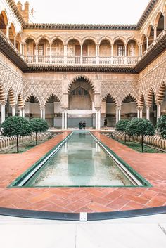 the courtyard of an old building with water in it