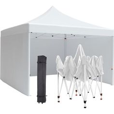 a white tent with four chairs under it