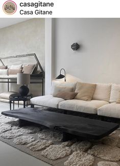 a living room filled with furniture and pillows on top of a white carpeted floor