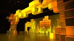 an empty room with yellow cubes on the ceiling and lights in the air above it