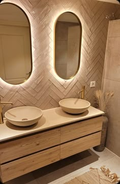 two sinks in a bathroom with mirrors above them