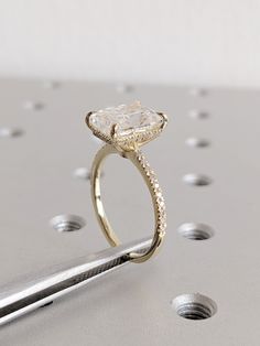 a close up of a diamond ring on a table