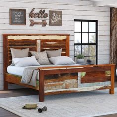 a bed that is made out of wood and has pillows on the top of it