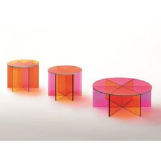 three tables with different colors and shapes on them