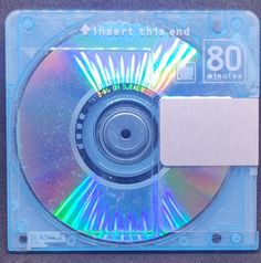 a cd that is sitting on top of a plastic case with a white tag attached to it