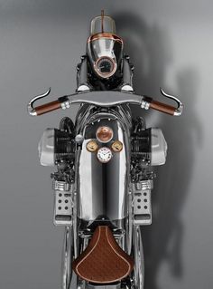 the back end of a silver motorcycle with a clock on it's front wheel