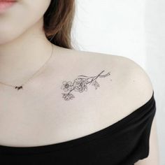 a woman with a flower tattoo on her chest