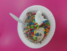 a paper plate topped with ice cream and sprinkles