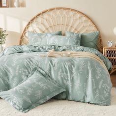 a bed with blue comforters and pillows in a room