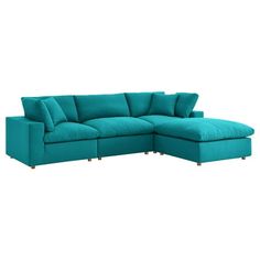 a blue sectional couch with pillows on it