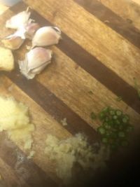 chopped up food sitting on top of a wooden cutting board