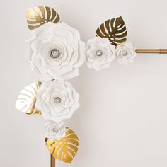 white and gold paper flowers on a stick