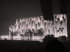 the band is performing on stage in front of an audience