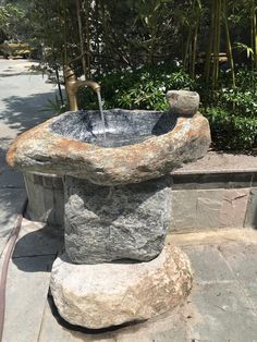 a stone fountain with water running from it