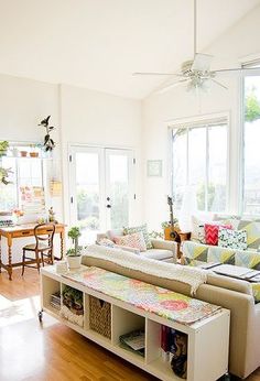 a living room filled with furniture and lots of windows