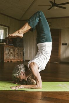 a woman is doing yoga on the floor