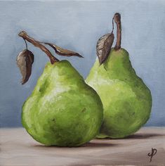 two green pears sitting on top of a table