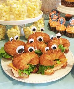 there are many croissants with googly eyes on them sitting on a plate