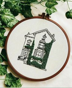 the embroidery pattern shows a house with ivy growing on it