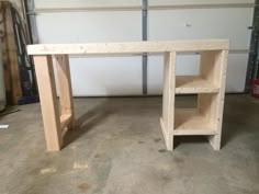 a wooden desk sitting inside of a garage