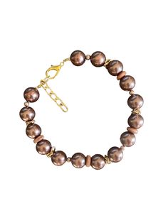 This exquisite chocolate pearl like beaded necklace is a statement piece. Featuring rich brown beads with a radiant luster, it's adorned with gold-toned accents that add an elegant and timeless charm. The adjustable chain ensures versatility and comfort, allowing you to wear it at your desired length. Handmade with attention to detail, this necklace is perfect for special occasions or to elevate your everyday look. Whether you're treating yourself or searching for a thoughtful gift, this piece w Brown Pearls Jewelry, Chocolate Pearls, Beaded Jewelry Necklaces, Brown Necklace, Necklace Elegant, Necklace Gold, Gold Accents, Everyday Look, Thoughtful Gifts